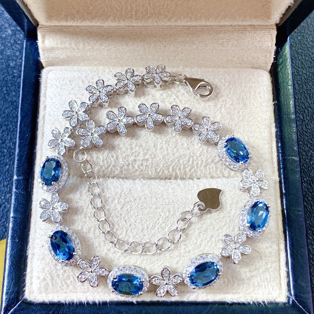 Silver bracelet with blue gemstones in a jewelry box