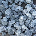 Close-up of blue stone chips on a dark surface