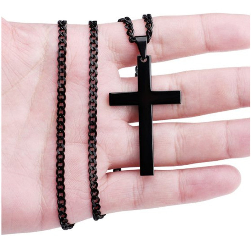 Black cross pendant necklace on a hand with two different chains.