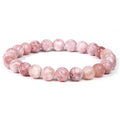 Pink beaded bracelet on a white background