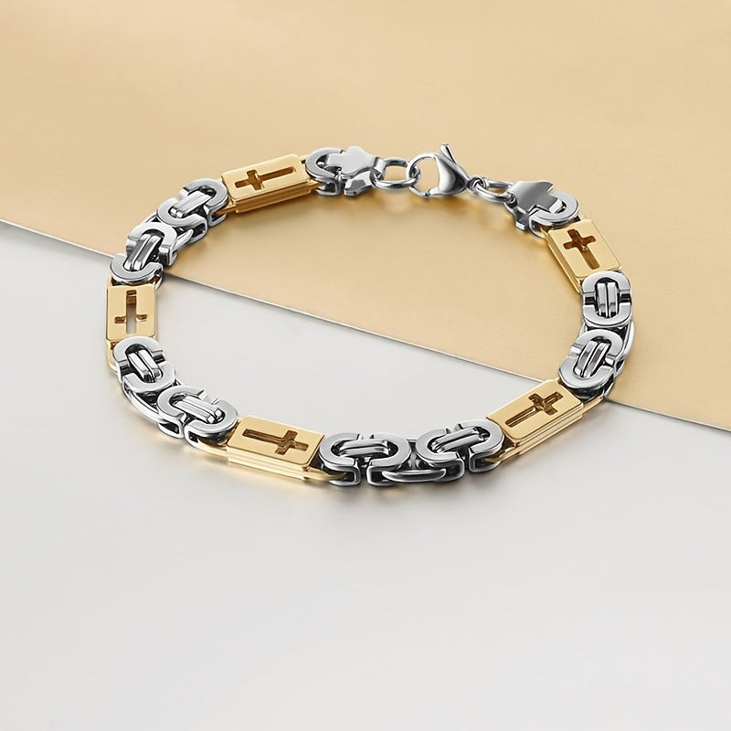 Silver and gold bracelet with cross designs on a light background