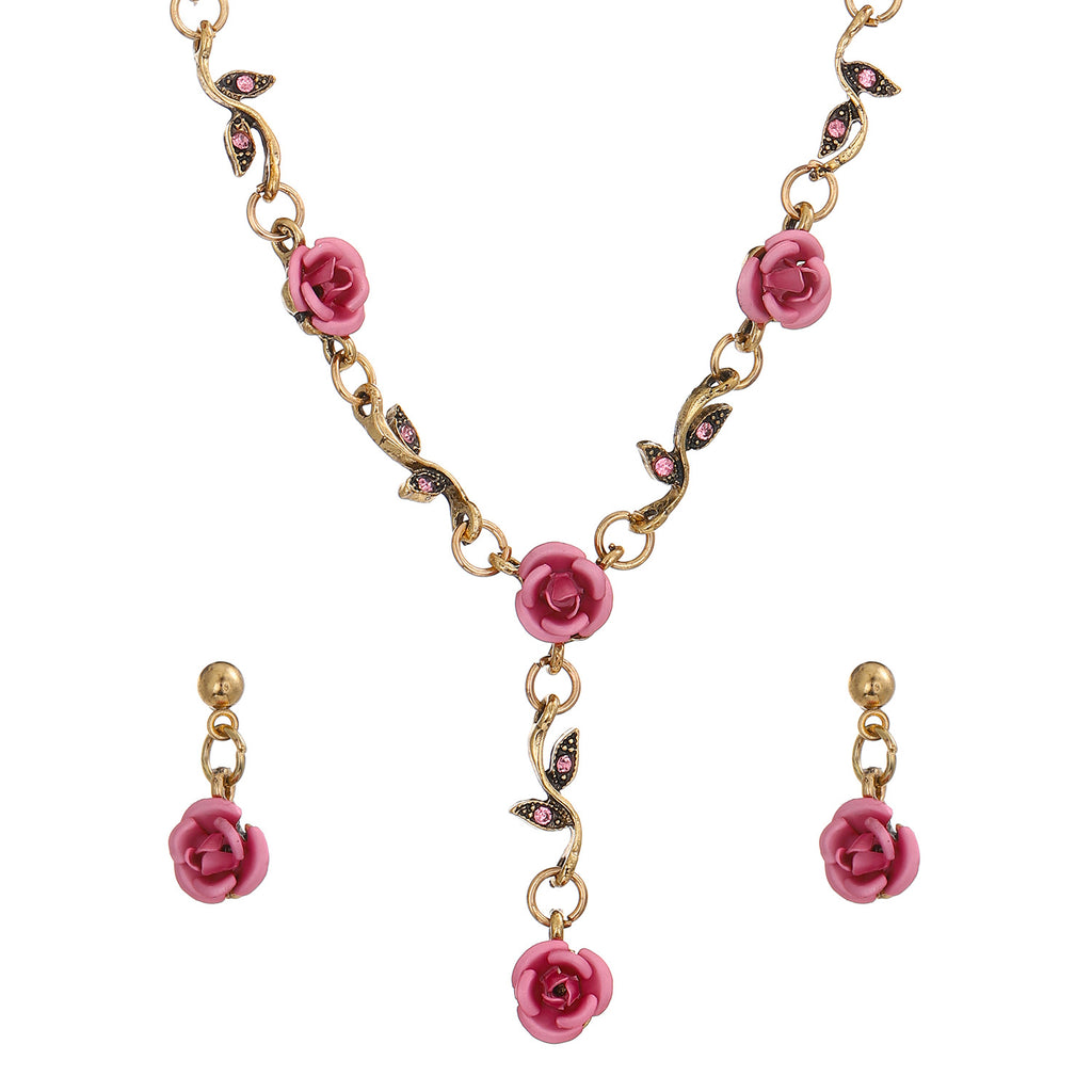 Jewelry set with pink rose-shaped pendants on a gold chain against a white background
