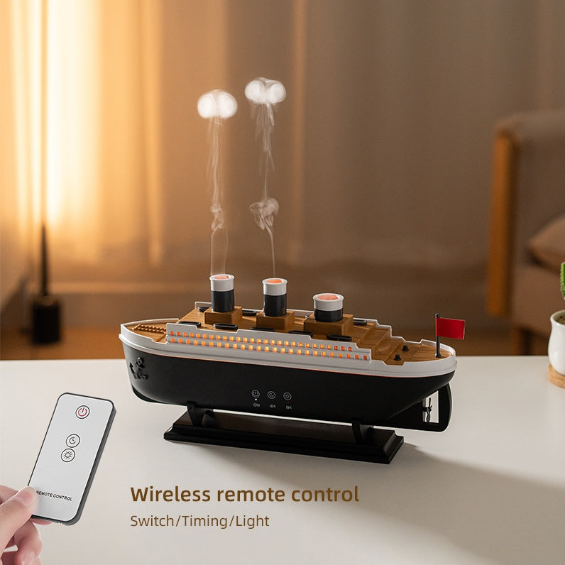 Model of a ship with smoke effect on a table, remote control in hand, in a room setting.