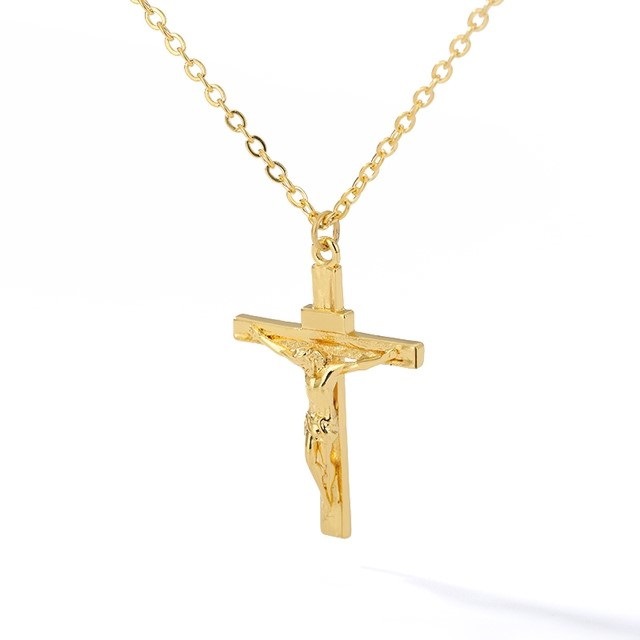 Gold crucifix pendant necklace on a white background