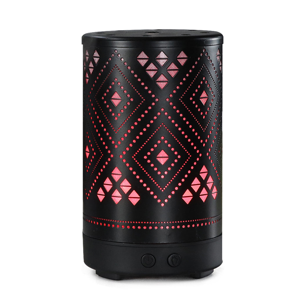 Black and pink patterned cylindrical device on a white background