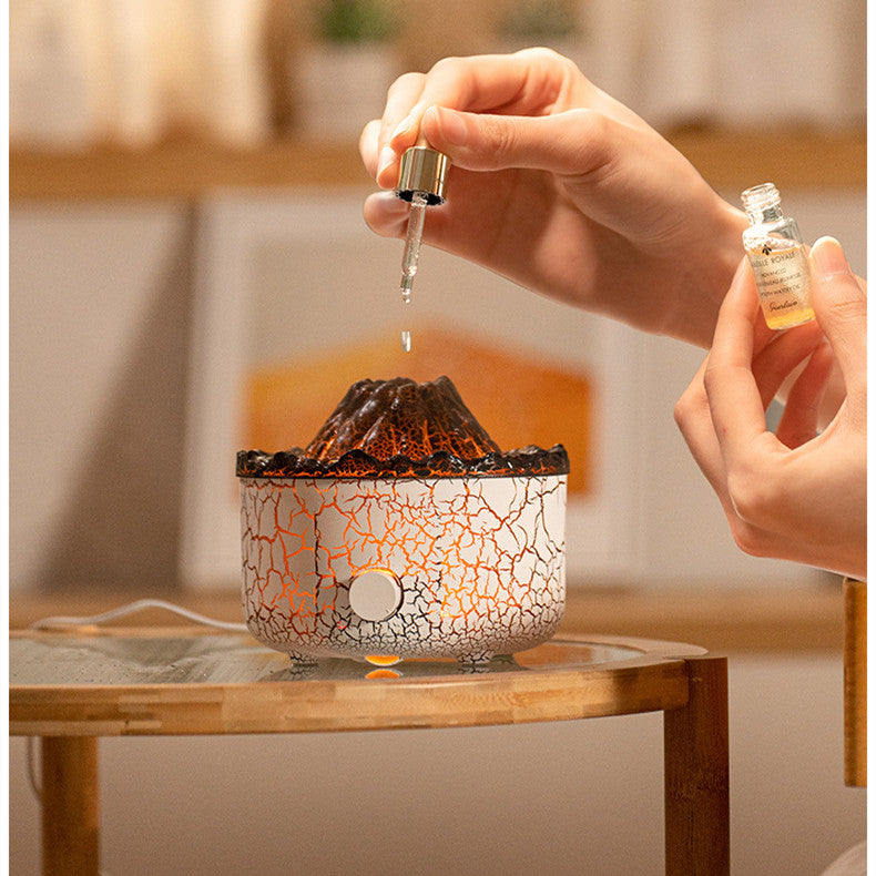 Person using a dropper to add liquid into a decorative lamp with a cracked design.