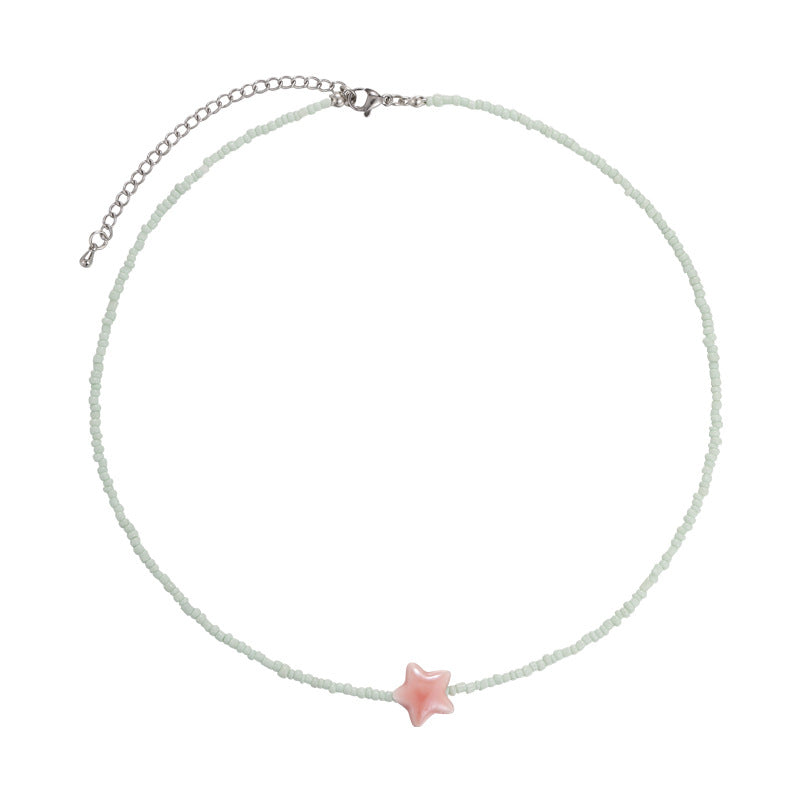 Necklace with a pink star pendant on a white background