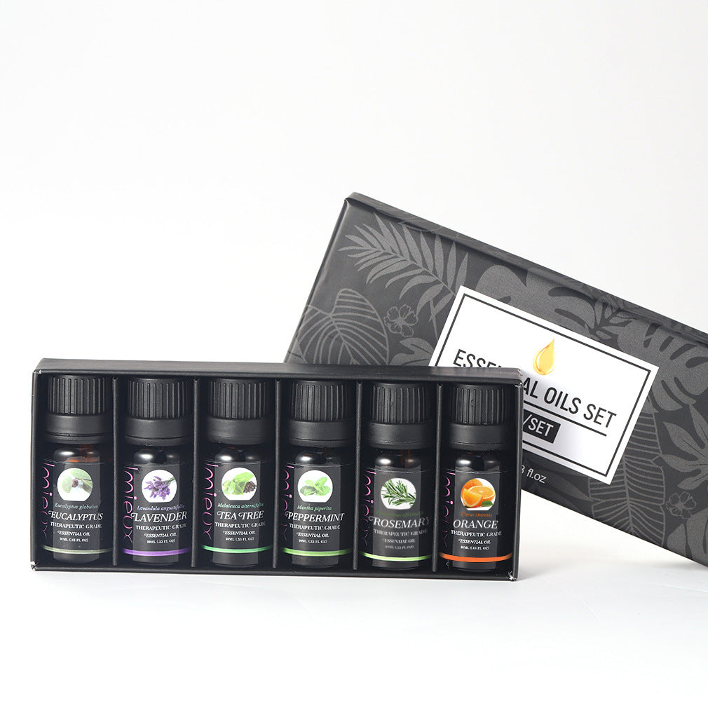 Set of essential oils with a decorative box on a white background