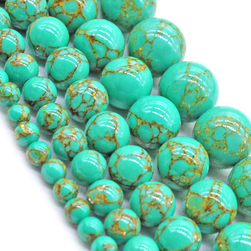 Turquoise beads with gold speckles on a white background
