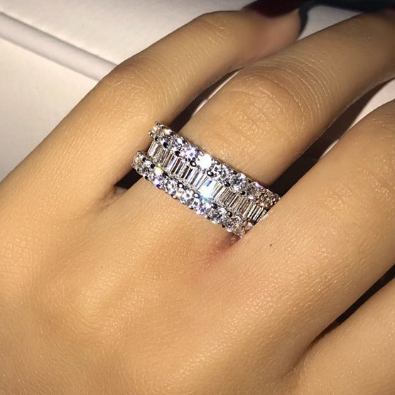 Diamond ring on a finger with a neutral background