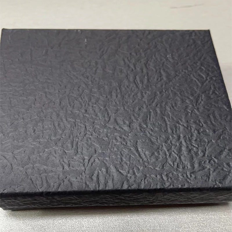 Textured black sheet on a light gray background