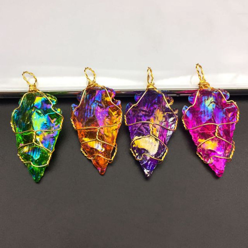 Four colorful stone pendants with gold wire wrapping on a gradient background