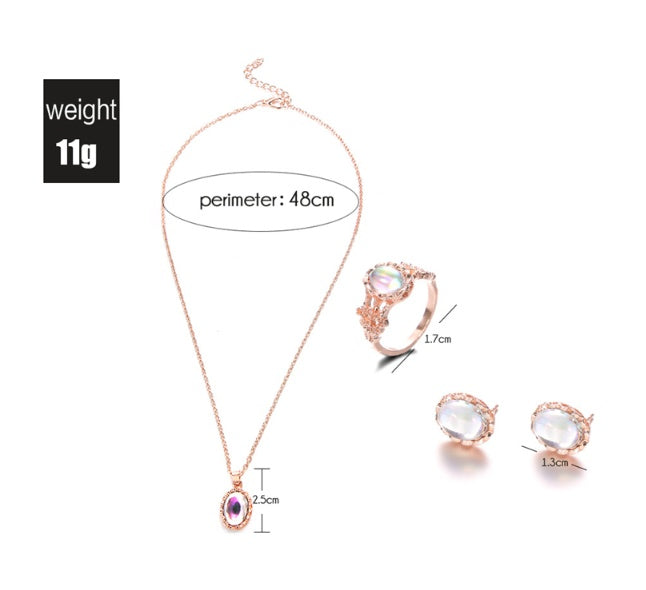Rose gold jewelry set with necklace, ring, and earrings on a white background