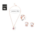 Rose gold jewelry set with necklace, ring, and earrings on a white background
