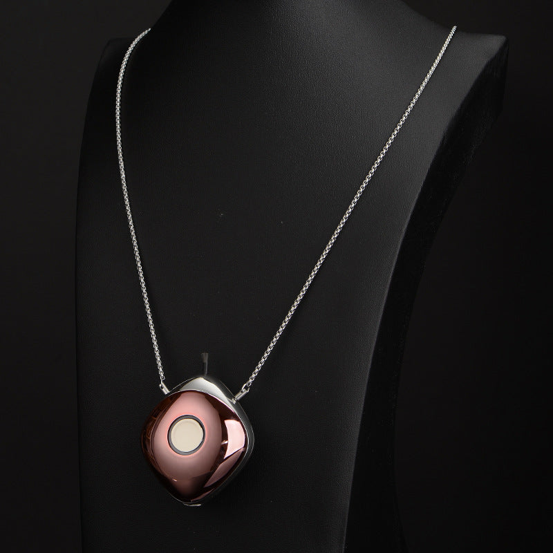 Necklace with a round pendant on a black mannequin
