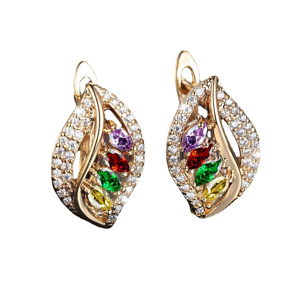 Pair of gold earrings with colorful gemstones on a white background