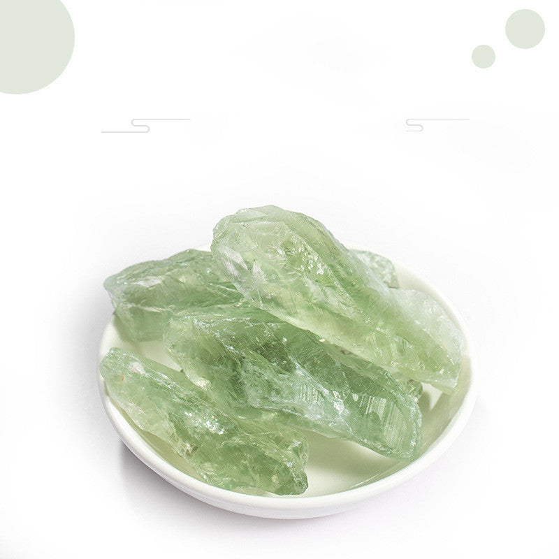 Green crystals on a white plate with a white background
