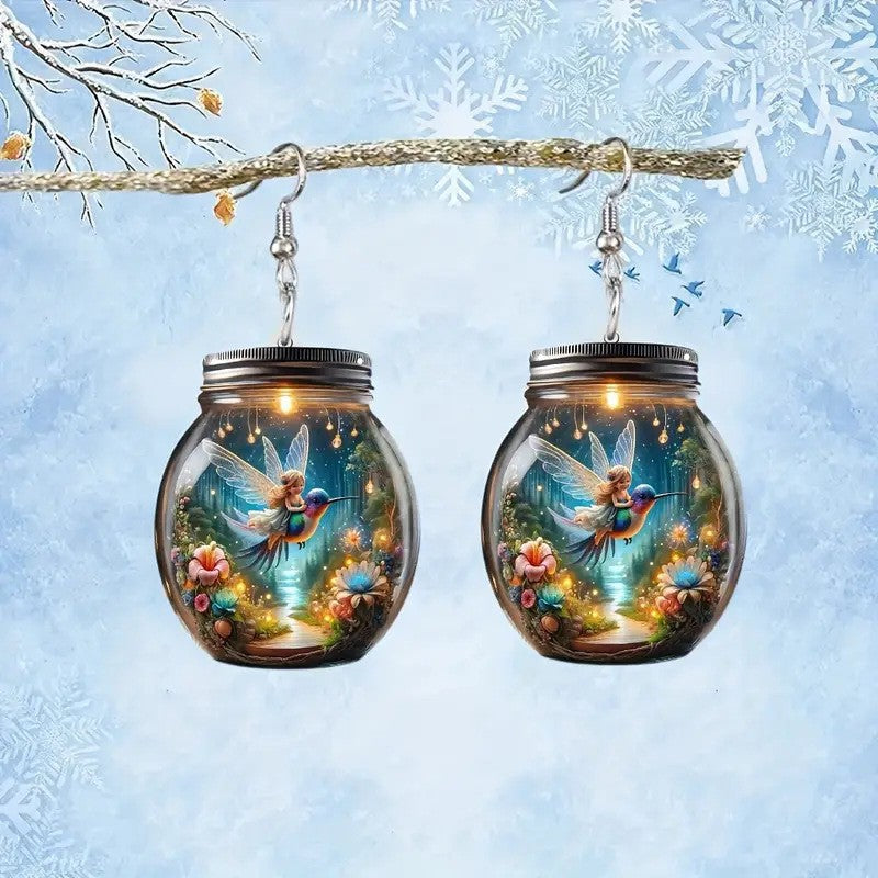 Earrings with fairy design inside glass jars against a snowy background