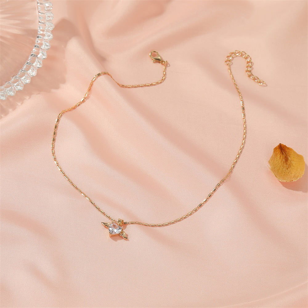 Gold bracelet with a star-shaped charm on a soft pink background