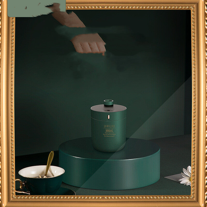 Green candle on a dark green platform with a gold-framed mirror reflecting a hand.