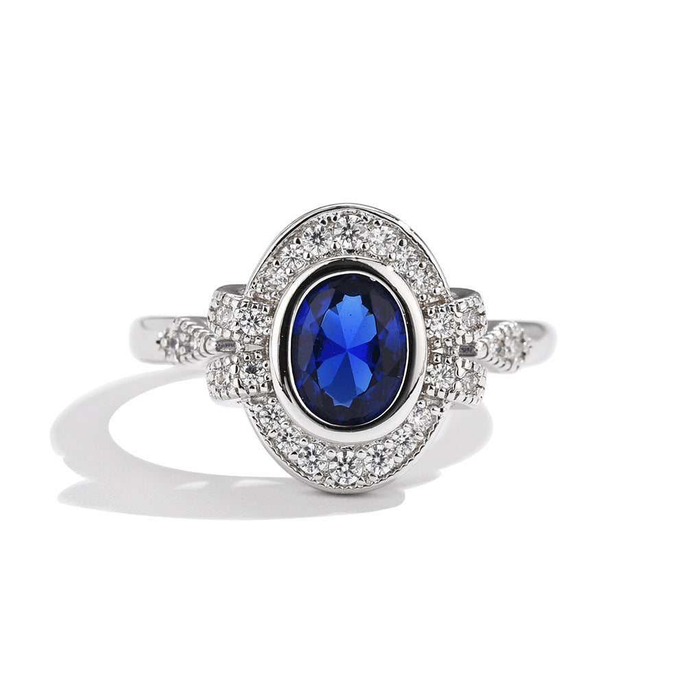 Silver ring with a blue gemstone on a white background