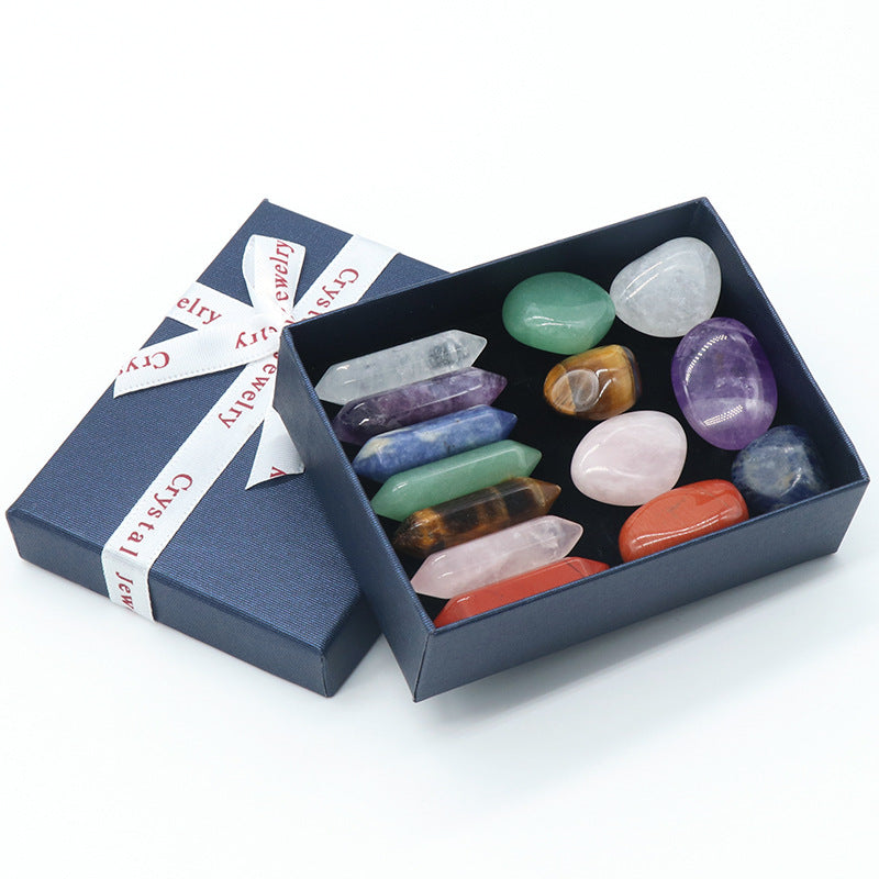 Set of colorful crystals in an open box with a branded ribbon on a white background