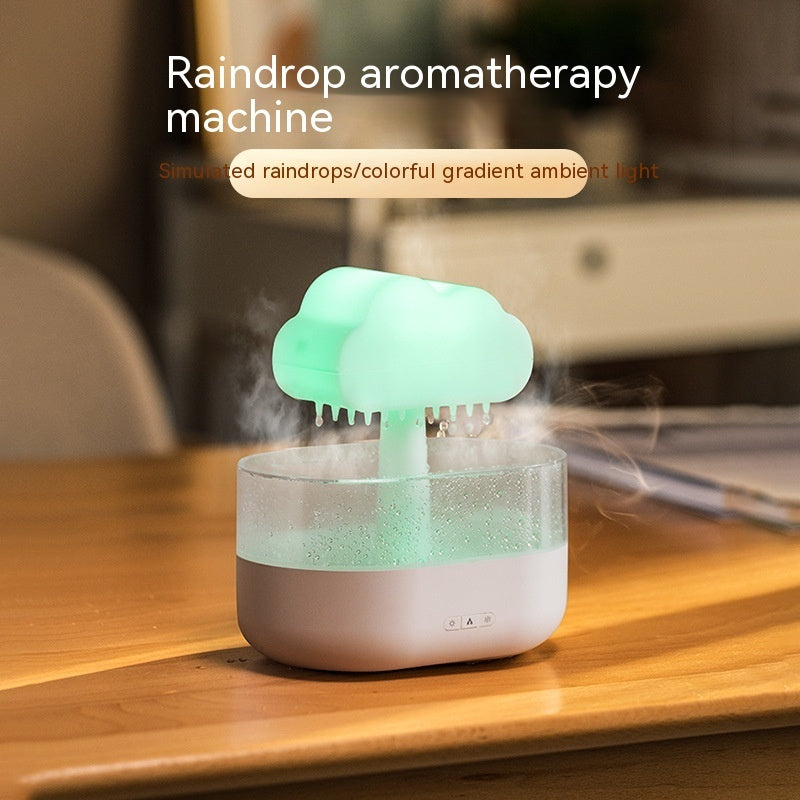 Raindrop aromatherapy machine emitting mist on a wooden surface with a blurred background