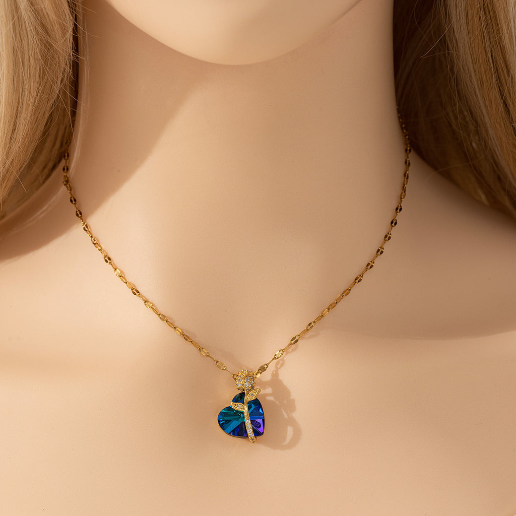 Necklace with a heart-shaped blue pendant on a mannequin