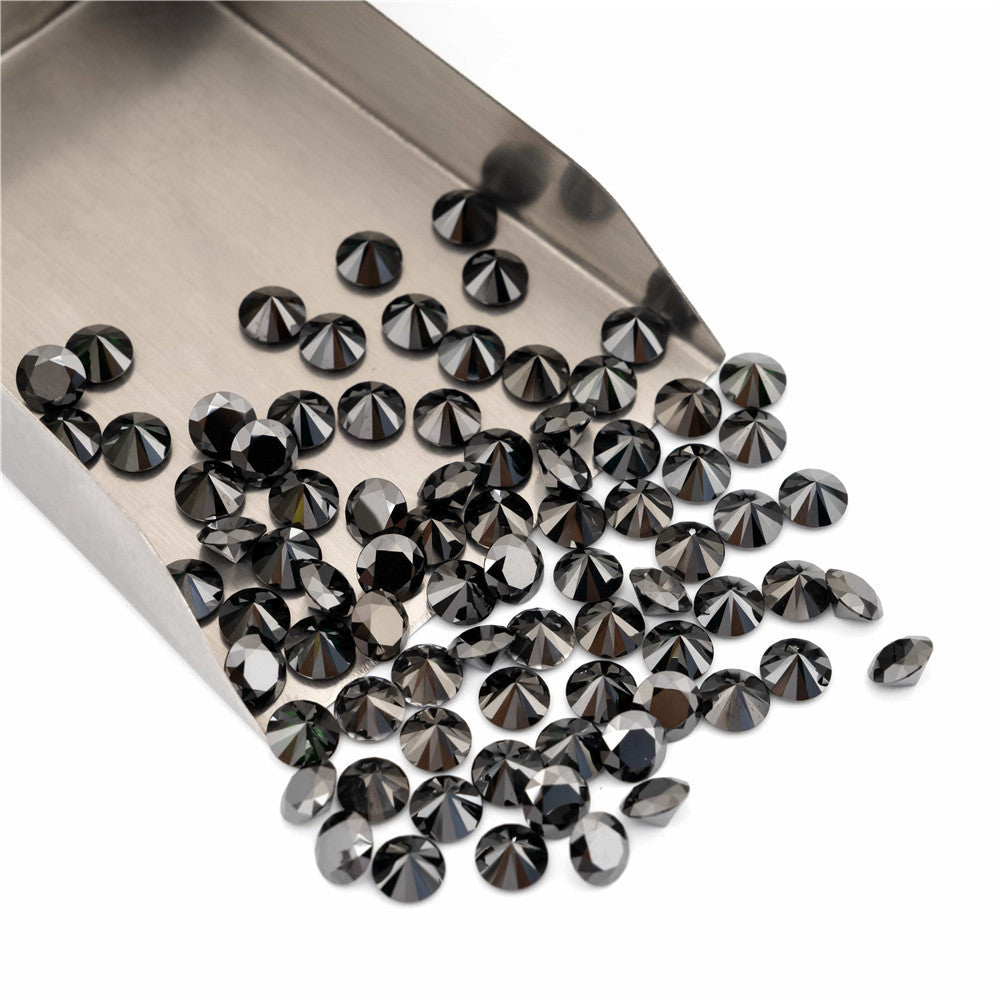 Collection of black diamonds on a metal tray with a white background