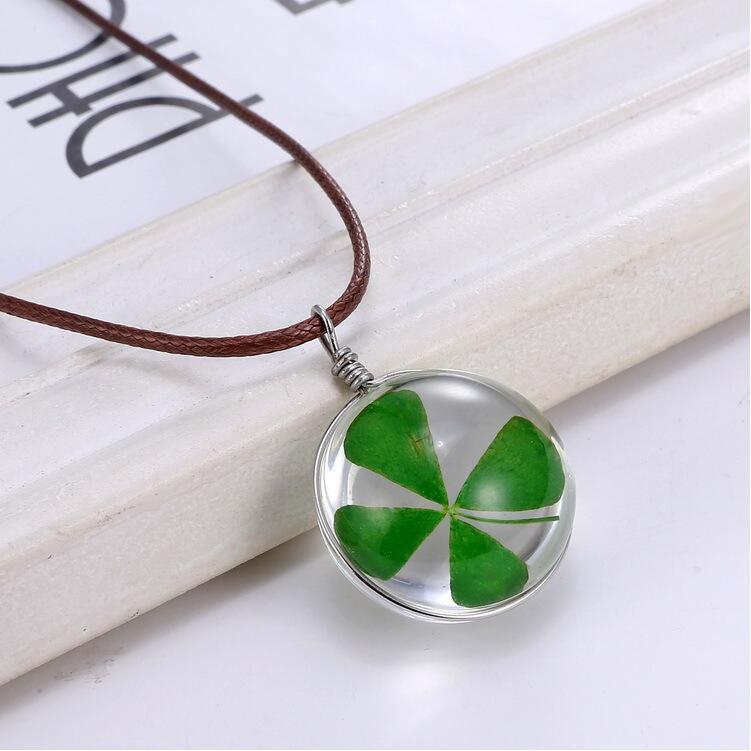 Four-leaf clover necklace on a white surface