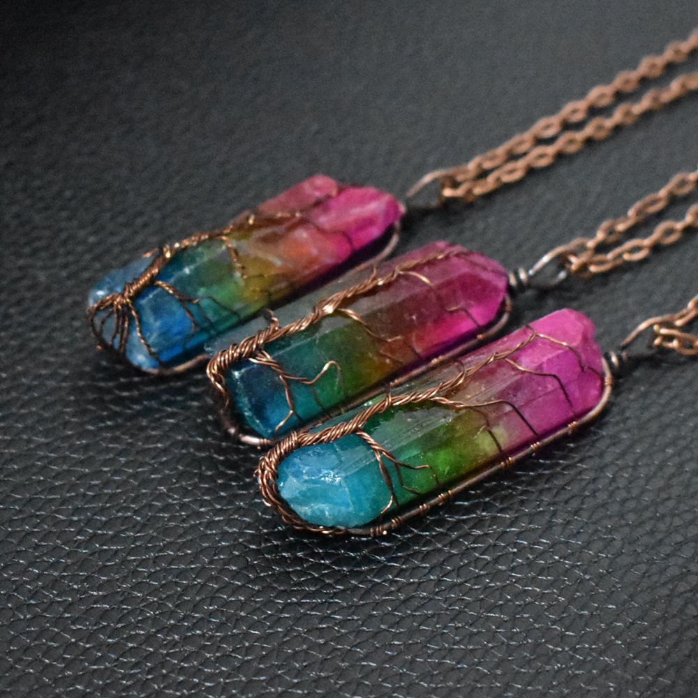 Necklace with multicolored stone pendants on a dark textured surface
