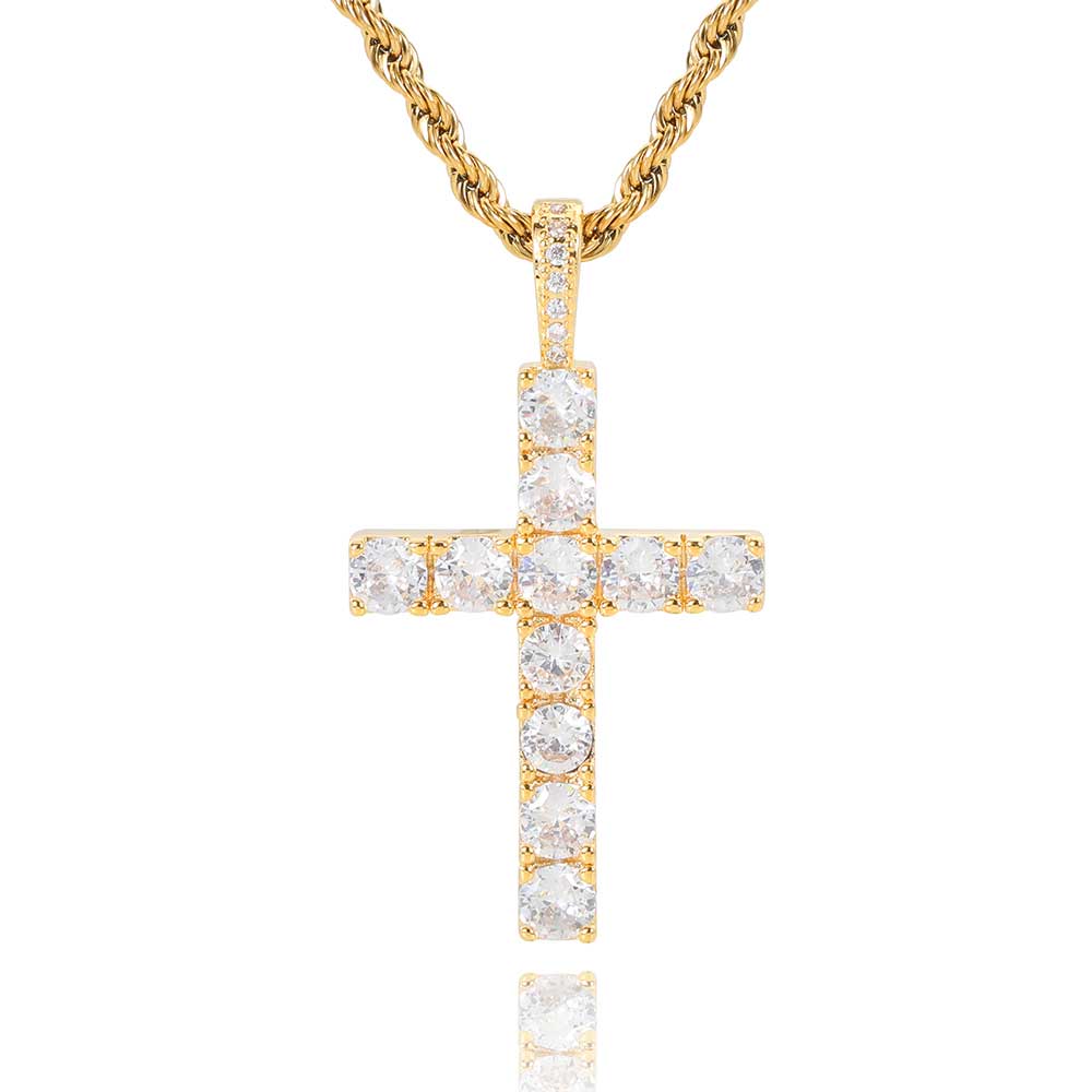 Gold cross pendant with clear stones on a gold chain against a white background