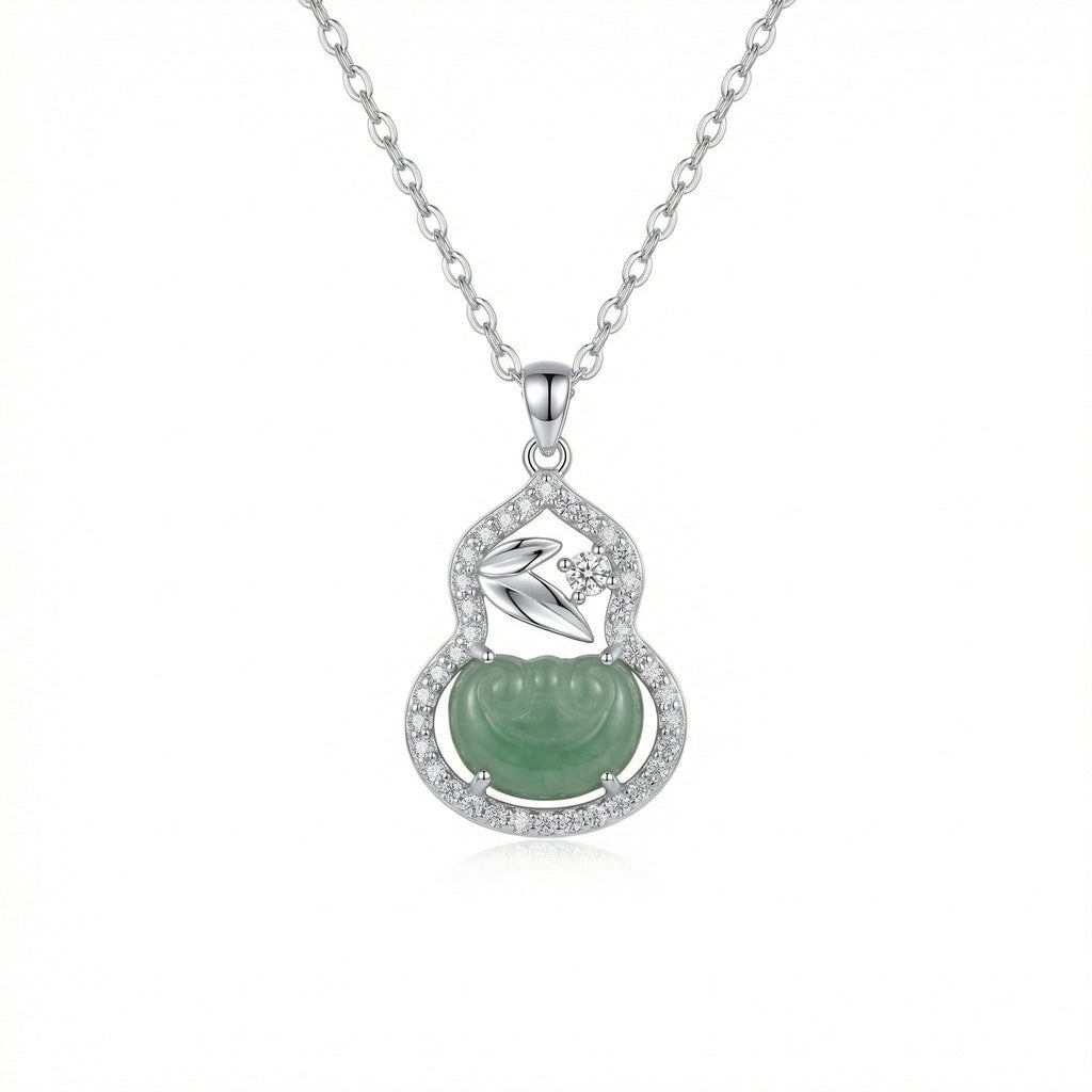 Silver necklace with a green pendant on a white background