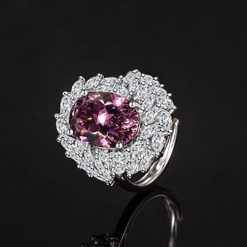 Ring with a pink gemstone and diamond-studded band on a black background