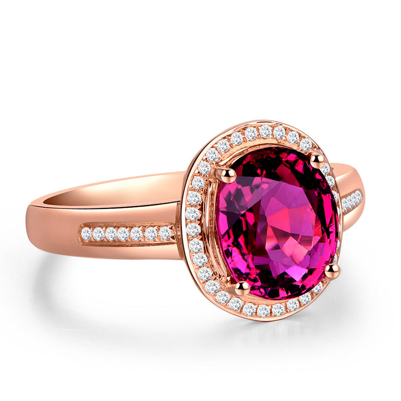 Rose gold ring with a pink gemstone and diamond accents on a white background