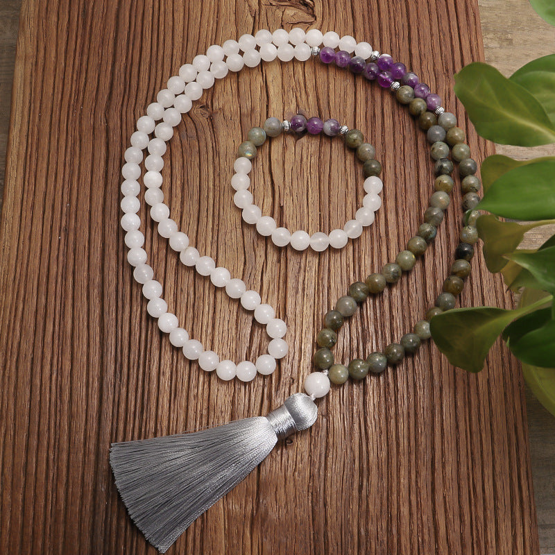 Beaded necklace with tassel on a wooden surface