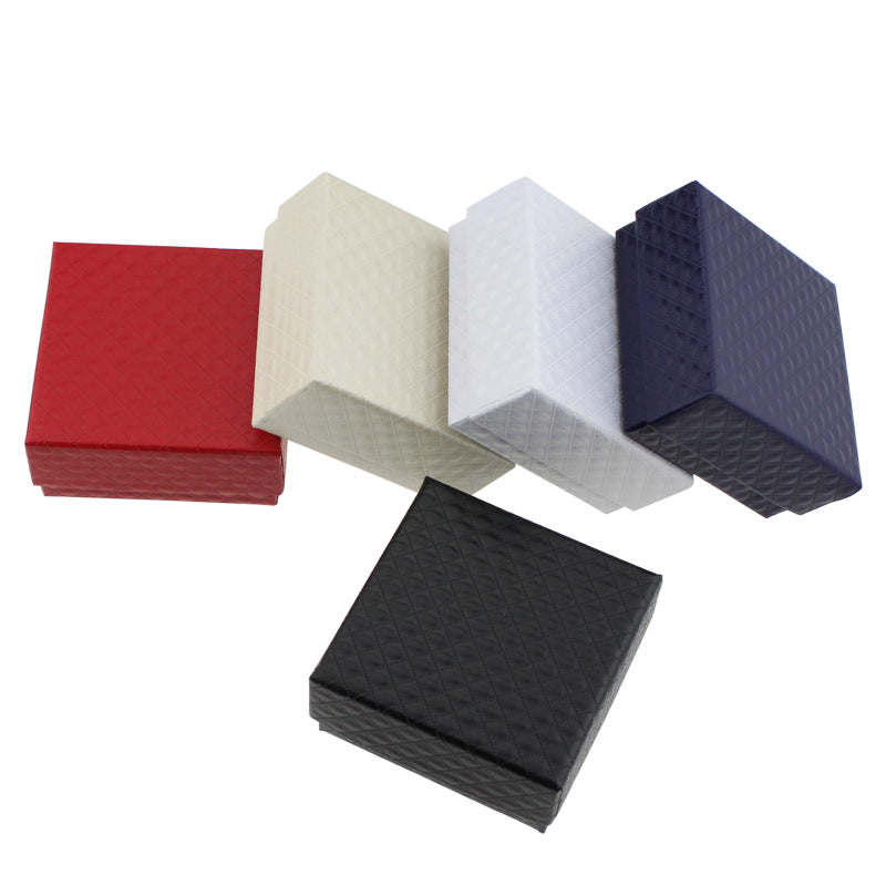 Five square blocks in red, beige, white, and black on a white background