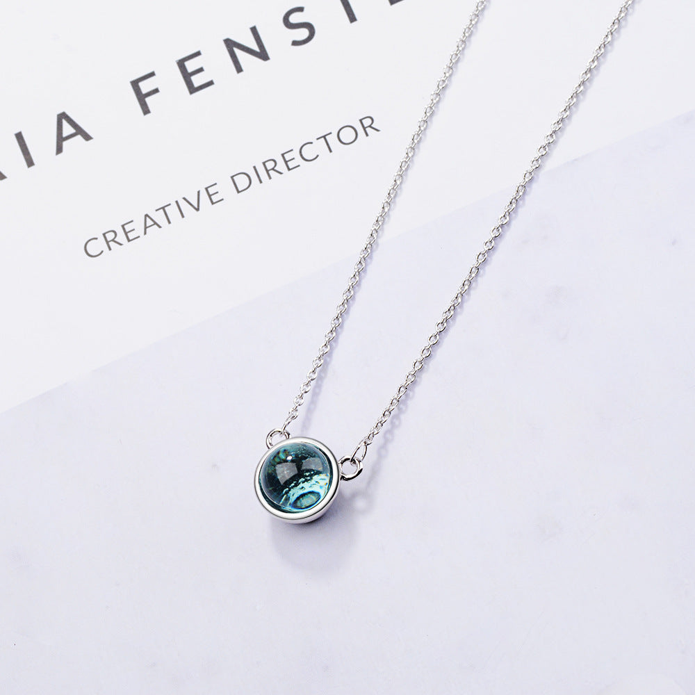 Necklace with a blue pendant on a white background