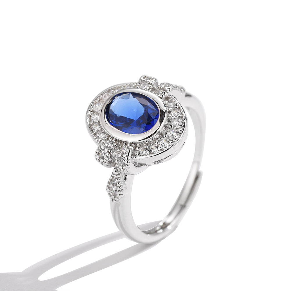 Silver ring with a blue gemstone on a white background