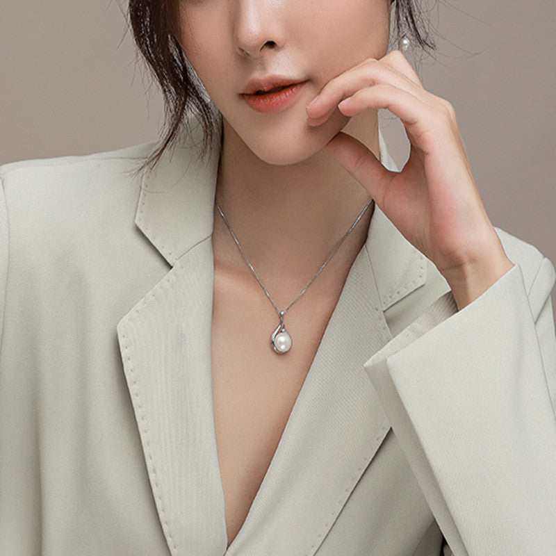 Woman wearing a pearl necklace with a neutral background