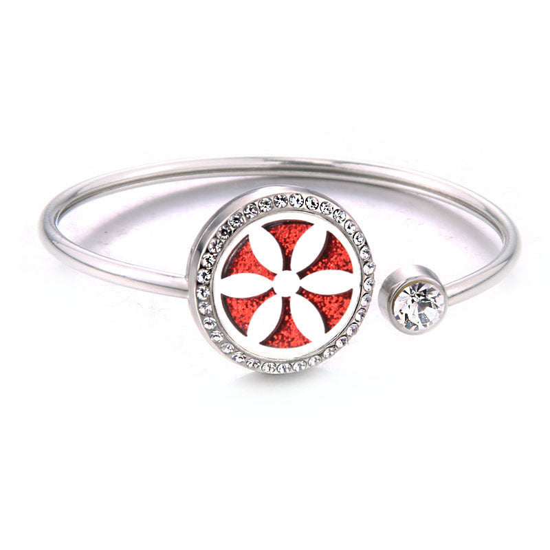 Silver bracelet with a red and white floral design on a white background