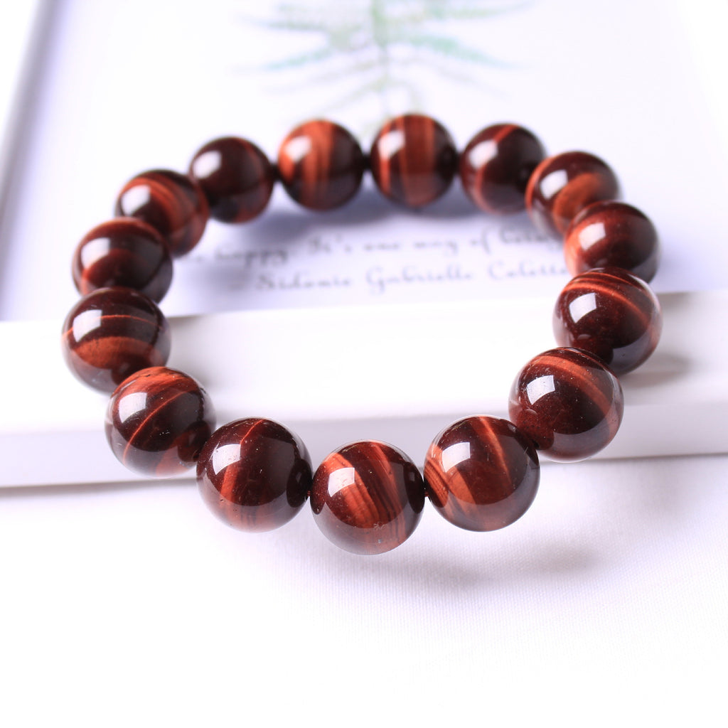Bracelet with red tiger eye beads on a white background