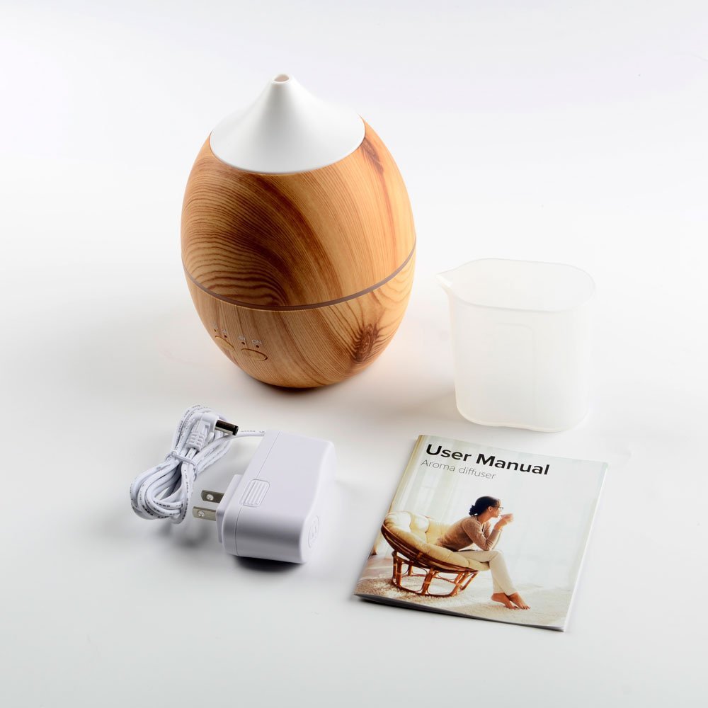Wooden diffuser with power adapter and user manual on a white background