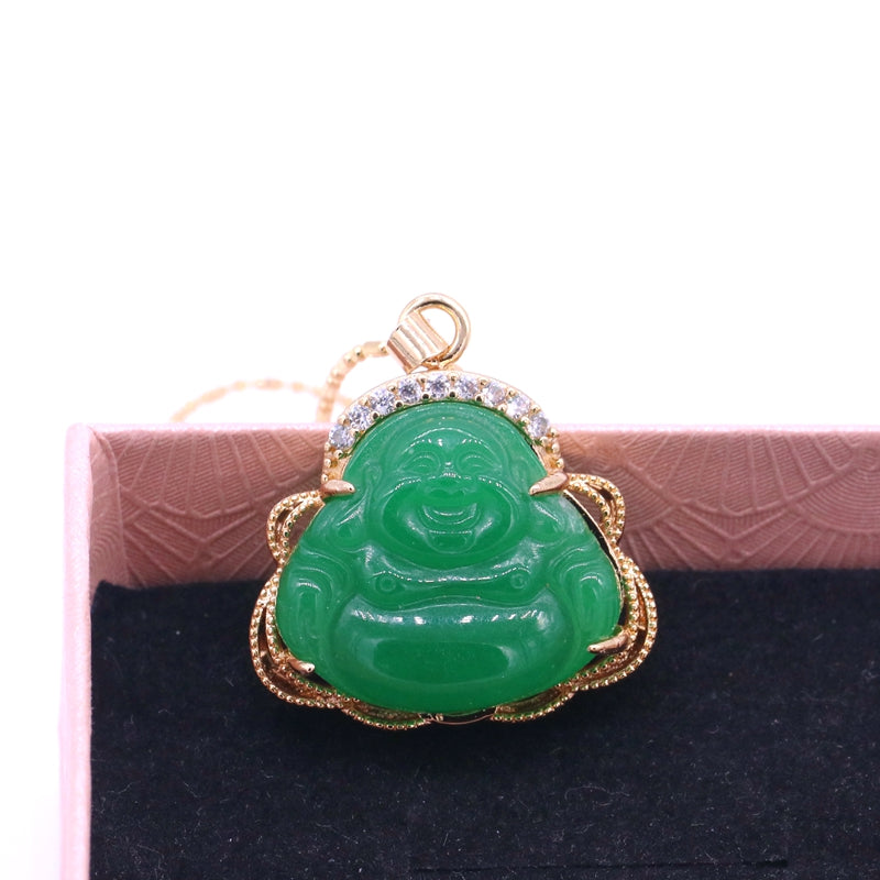 Green jade Buddha pendant with gold frame on a black and pink textured background