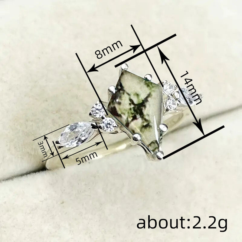 Jewelry ring with gemstones and measurements on a white background