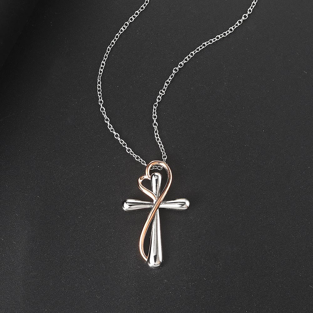 Necklace with a cross pendant on a black background
