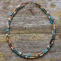 Multicolored beaded necklace on a wooden surface