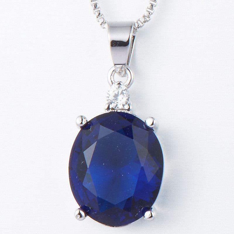 Blue gemstone pendant on a white background