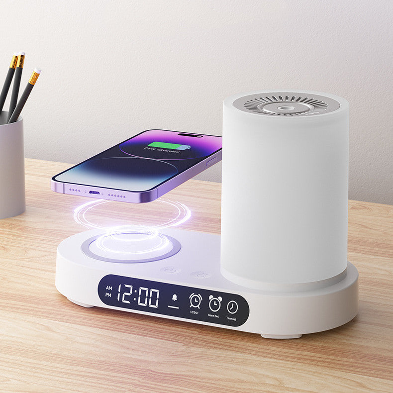 White electronic device with digital display and wireless charging pad on a wooden surface.