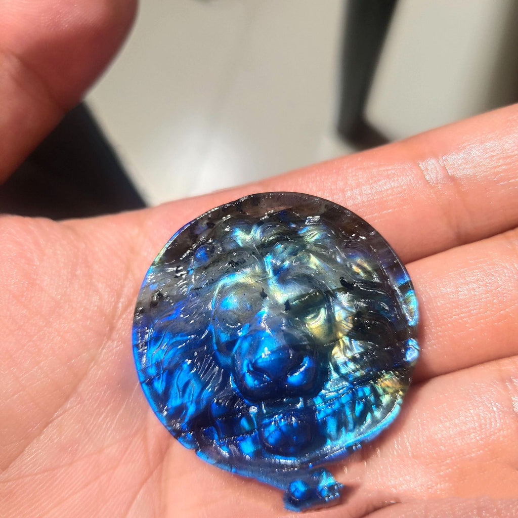 Blue and black marbled stone held in a hand